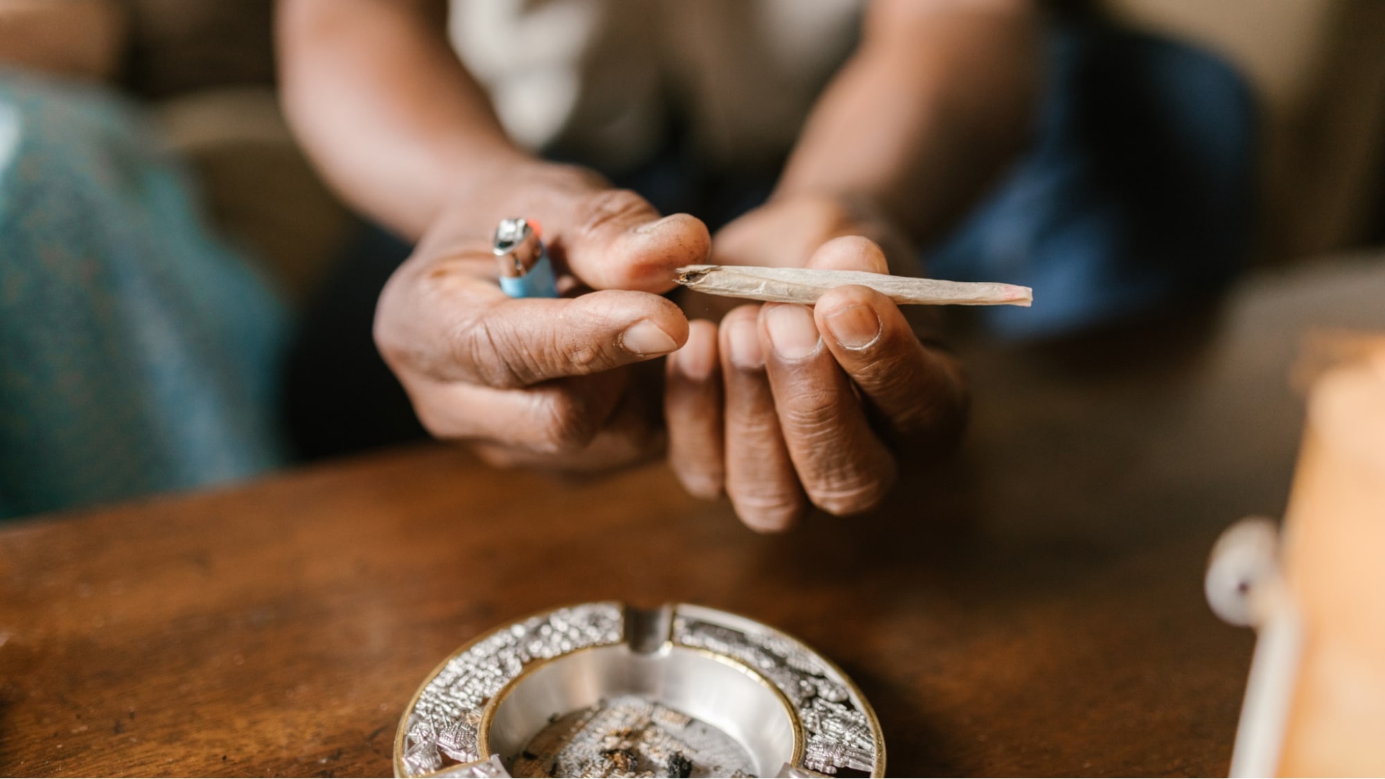 Hands holding and rolling a joint